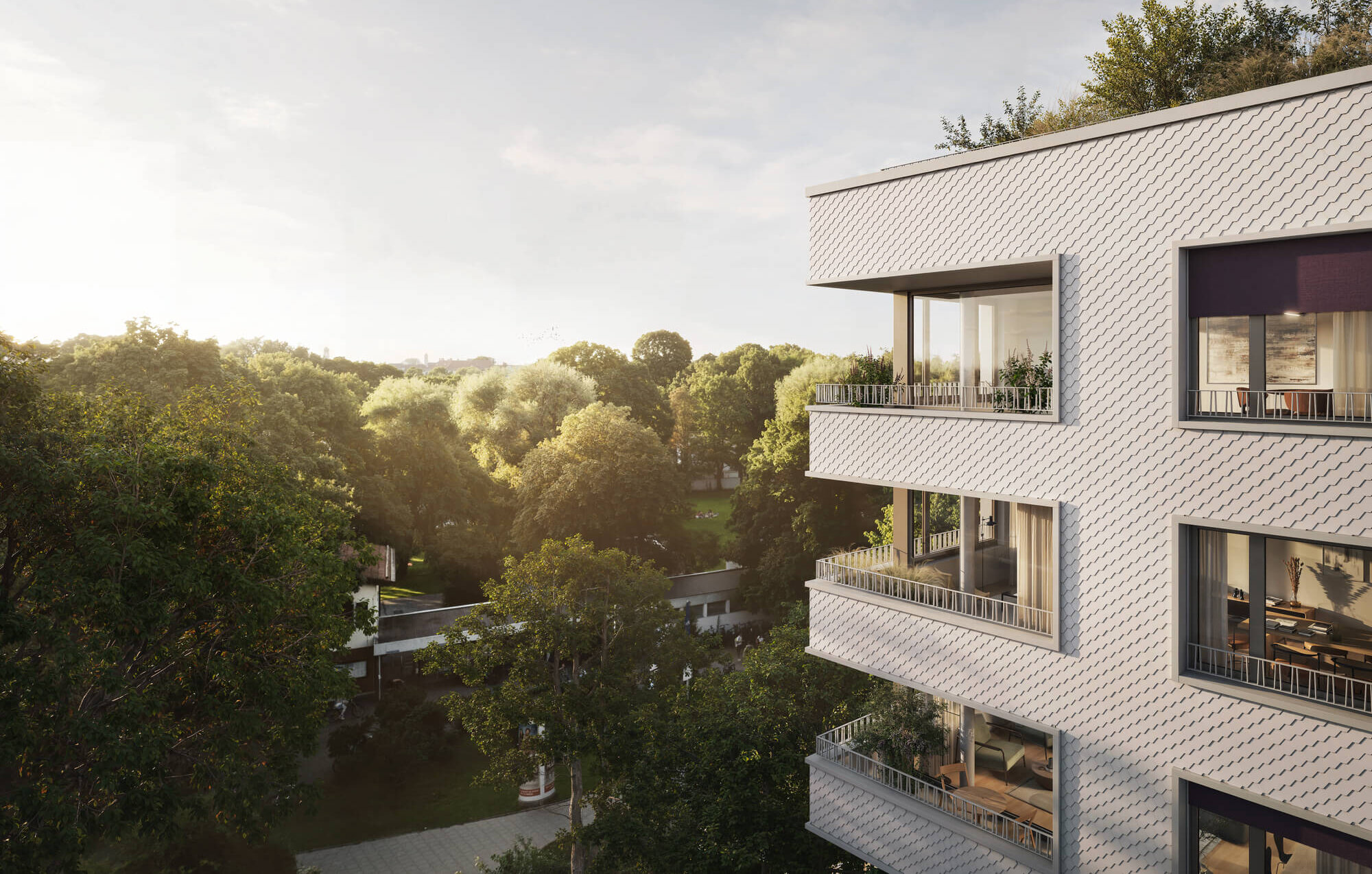 Außenansicht mit Balkonen vor Bäumen im Neubauprojekt Haus Claude Untergiesing