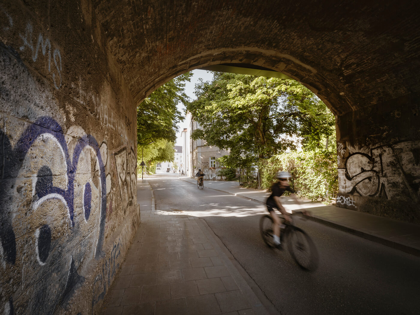 Unterführung in Untergiesing mit Graffiti und Radfahrer im Alltagsverkehr