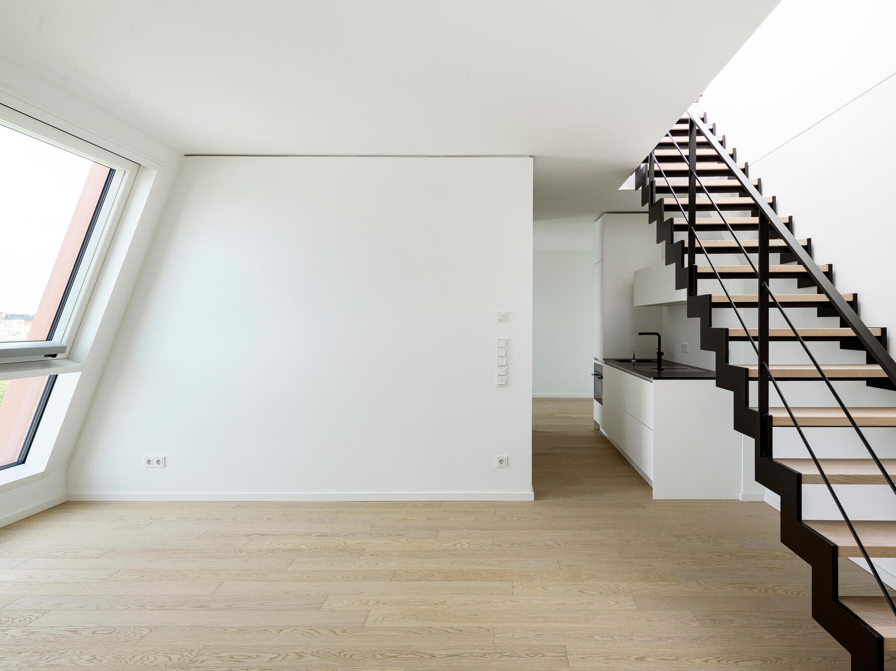 Wohnbereich mit Einbauküche, Treppe und Dachfenstern in Rooftop Flat Van B