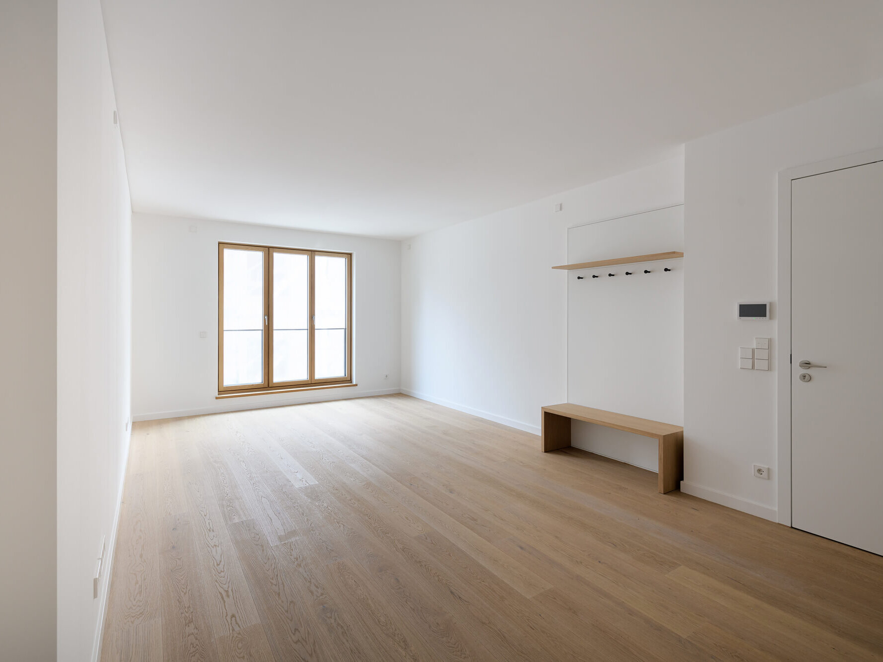 Wohnraum mit Garderobe in Wohnung W1.3 im Neubau-Ensemble Amalie, München